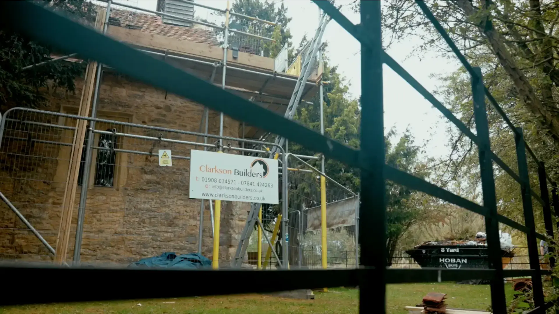 Clarkson Roofing operatives working on a residential slate roof in Buckinghamshire, close detail of slate alignment and lead flashing.