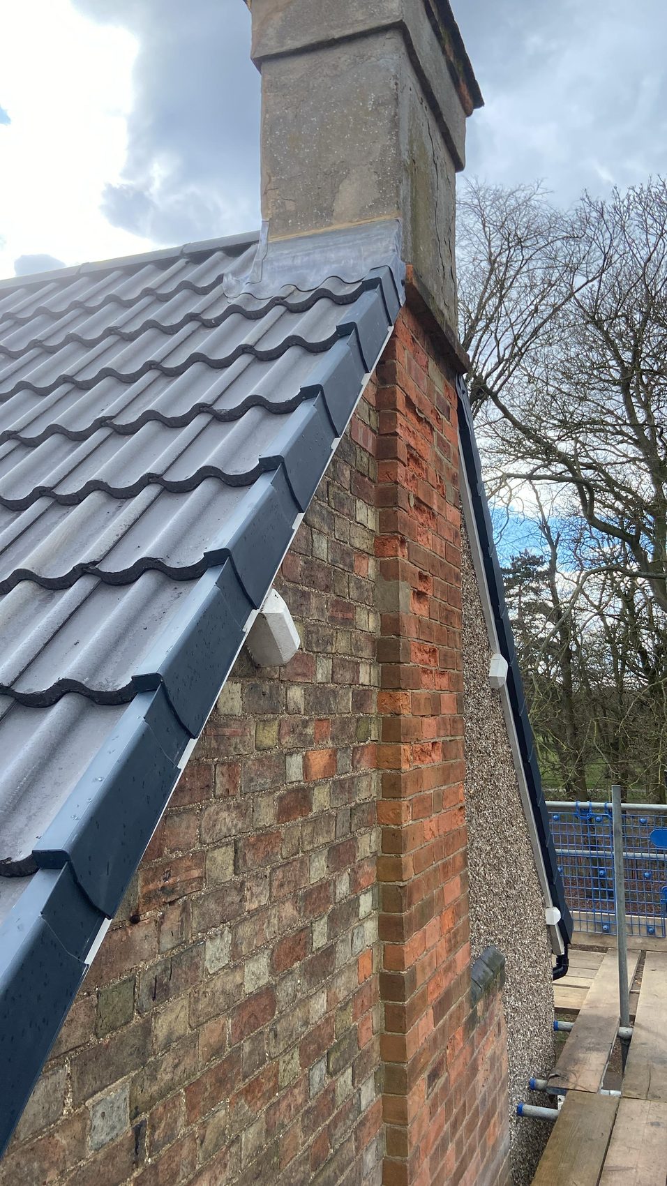 Grey tiled roof with rebuilt chimney and lead flashing, Bedford