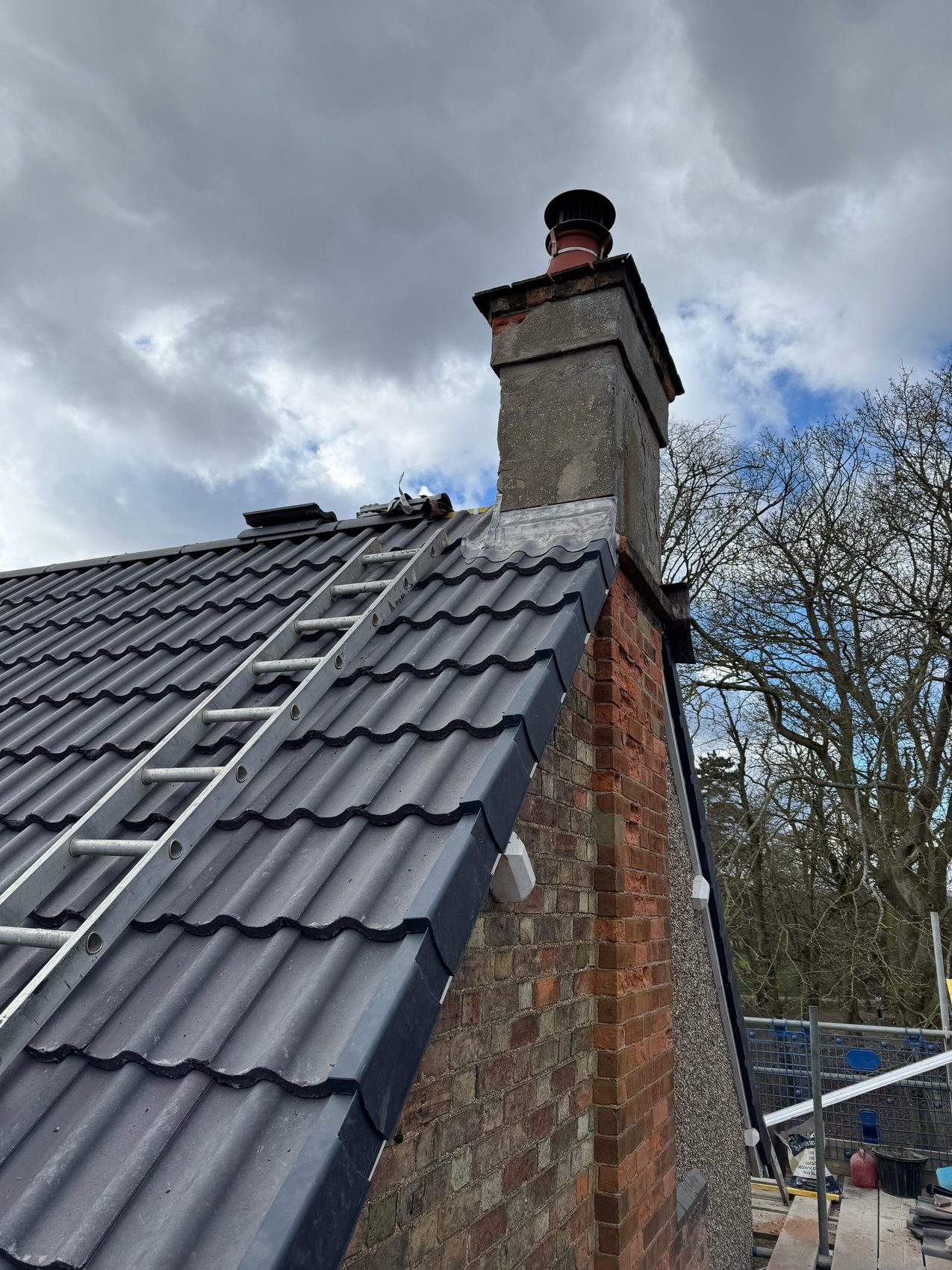 Grey tiled roof with a rebuilt brick chimney and fresh lead, Bedford