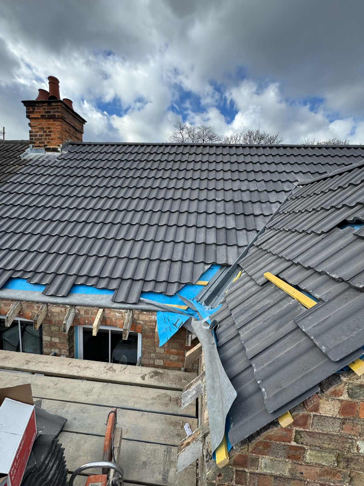 01 · The roof opened up mid-strip, underlay and battens exposed