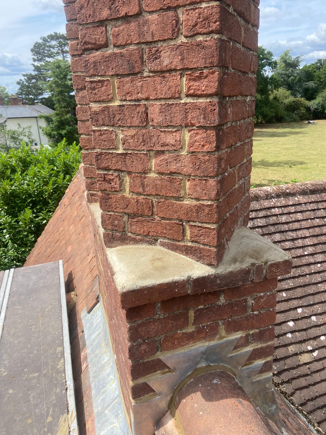 Freshly re-flaunched chimney shoulder with new sand and cement weathering