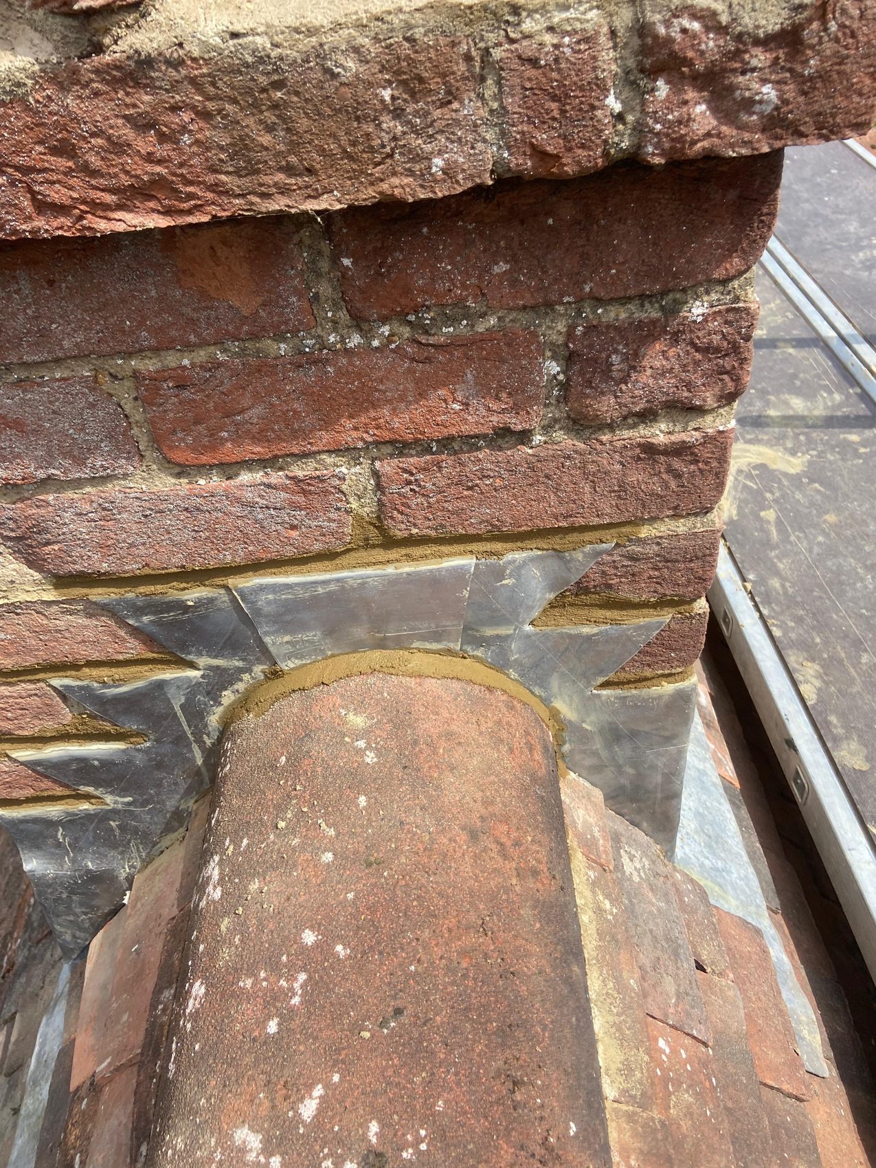 New lead flashing dressed around the ridge tile at the chimney junction