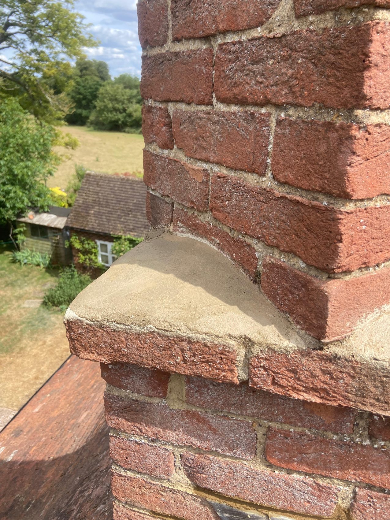 Fresh mortar weathering on the re-flaunched chimney shoulder