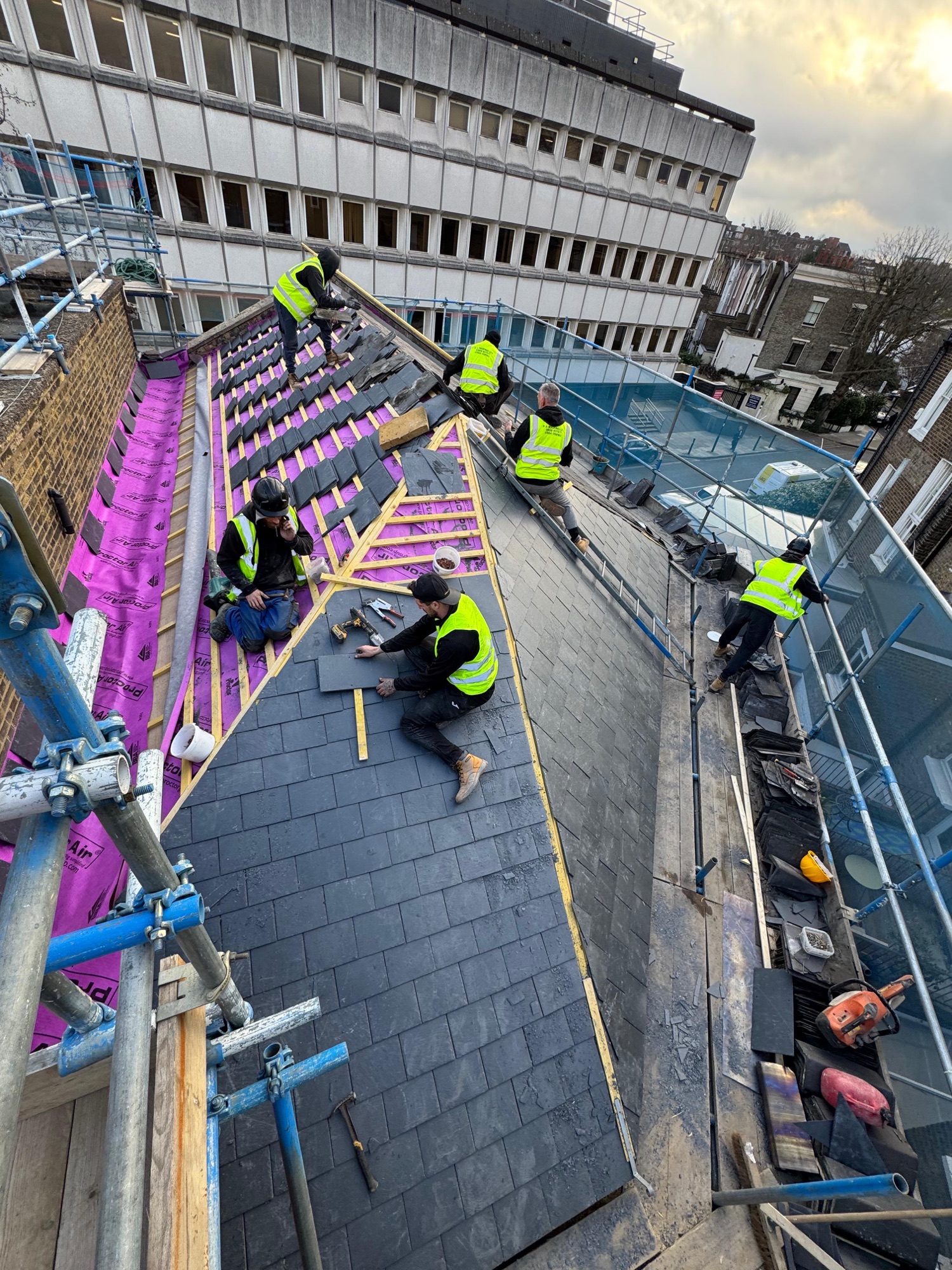 The Clarkson team hand-slating a large natural slate roof in London
