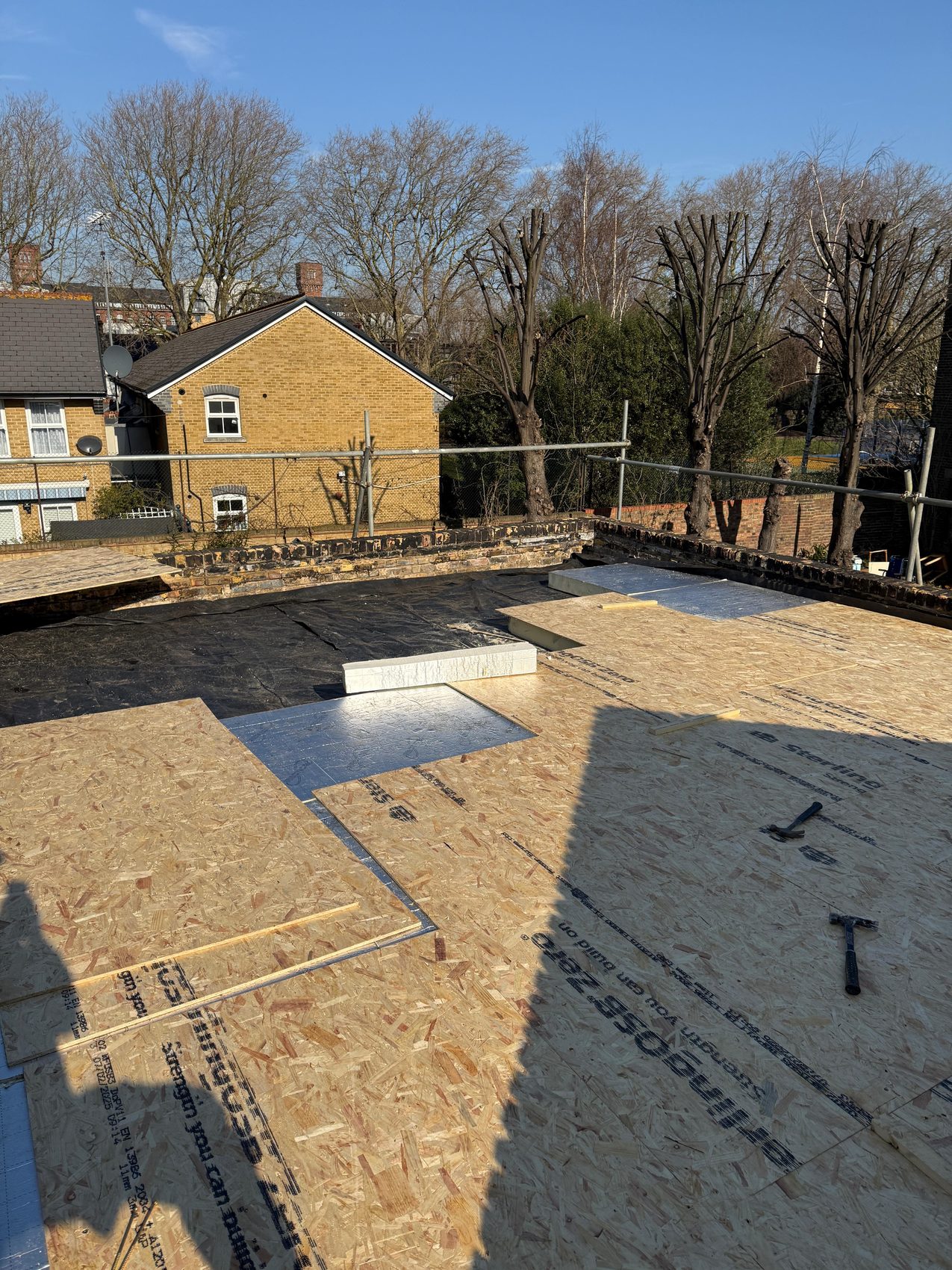 Insulation boards and decking building up the warm flat roof