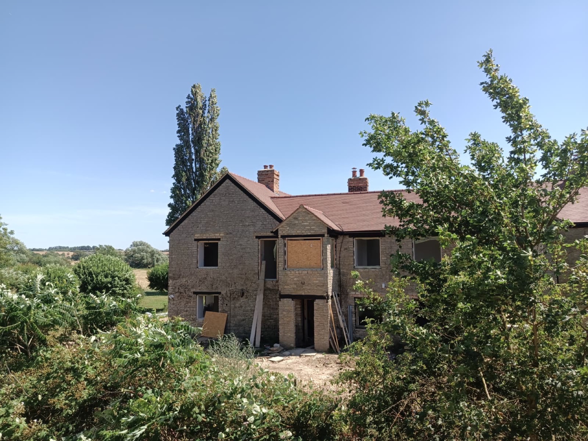 Completed Ravenstone Mill re-roof, finished stone-clad property with fresh red clay tile