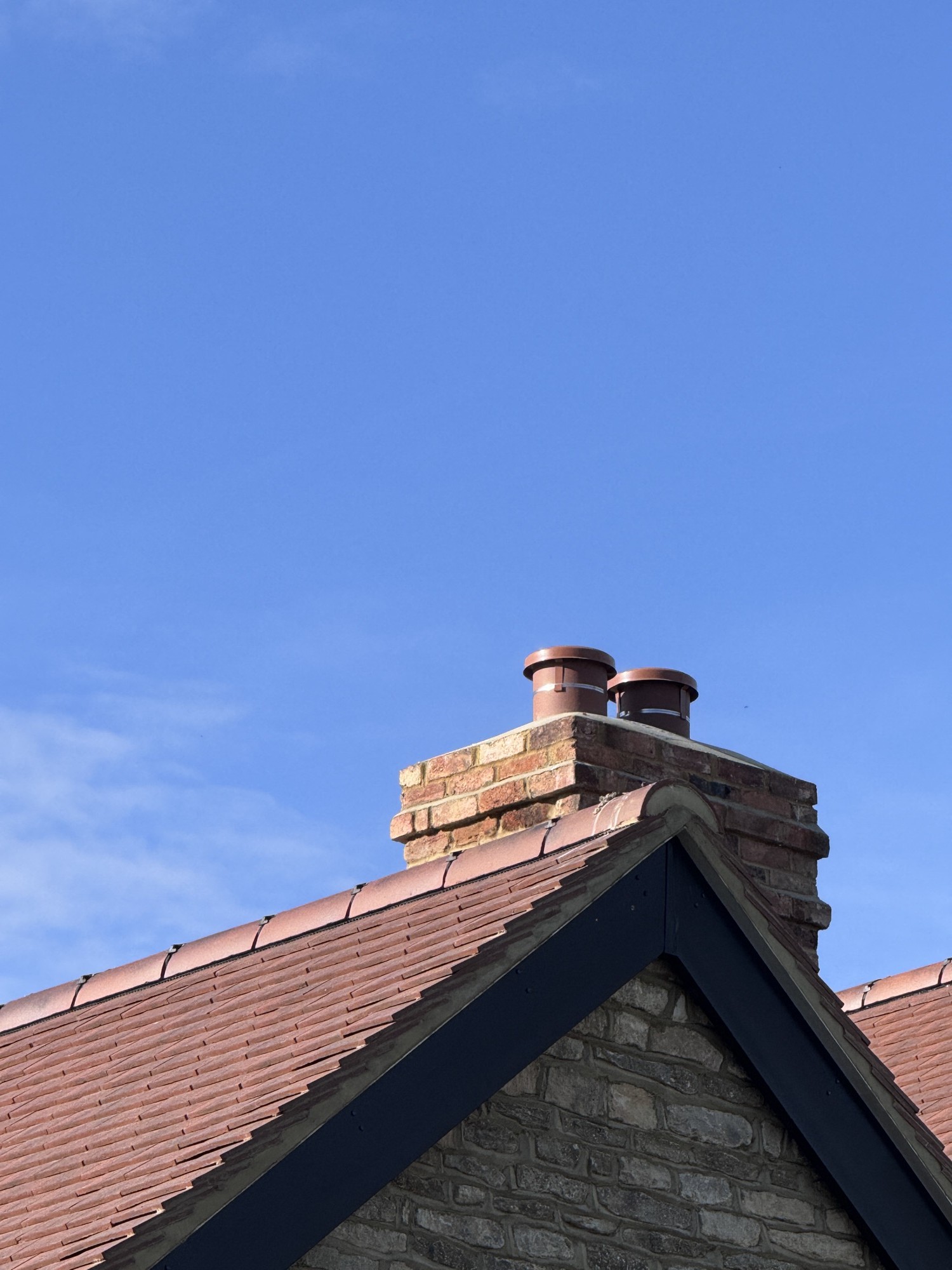 Completed clay tile re-roof with a rebuilt chimney in Buckinghamshire by Clarkson Roofing