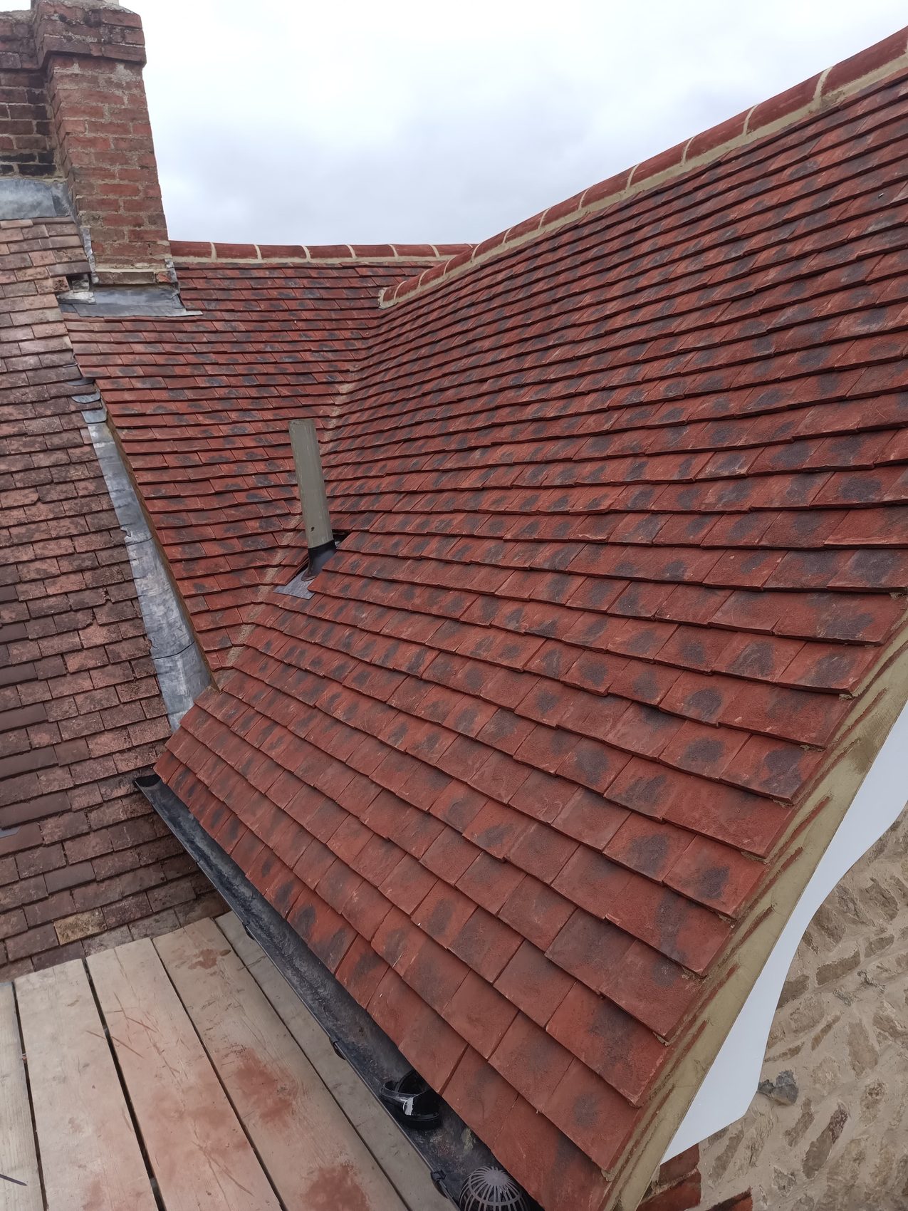 Finished clay plain-tile pitched roof on a house