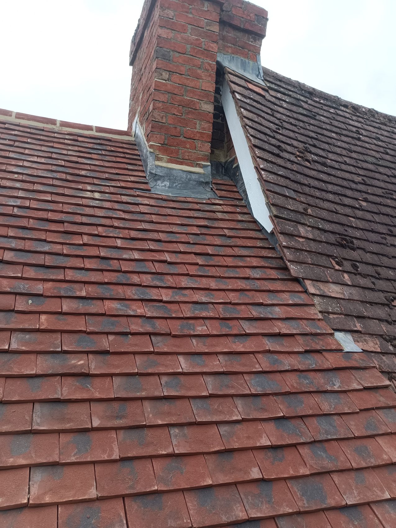 Old weathered tiles on the existing Sherington roof at the strip stage