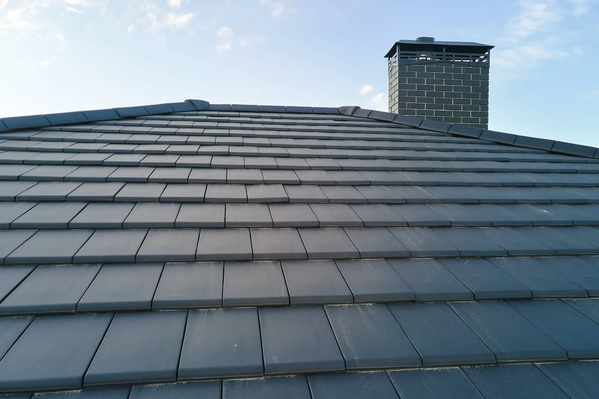 Natural slate pitched roof close up, showing hand cut courses.