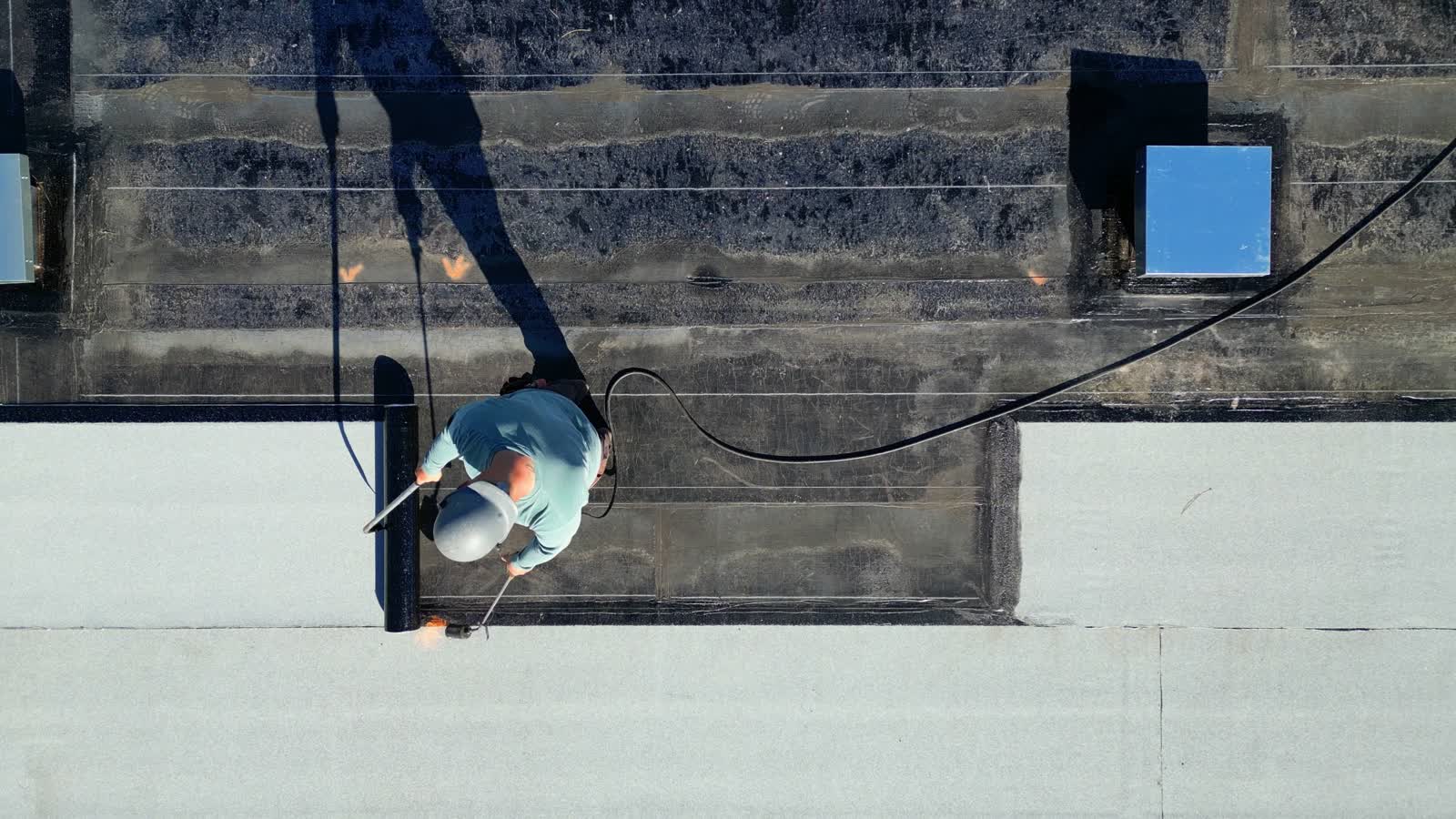 Commercial flat roof being installed from above