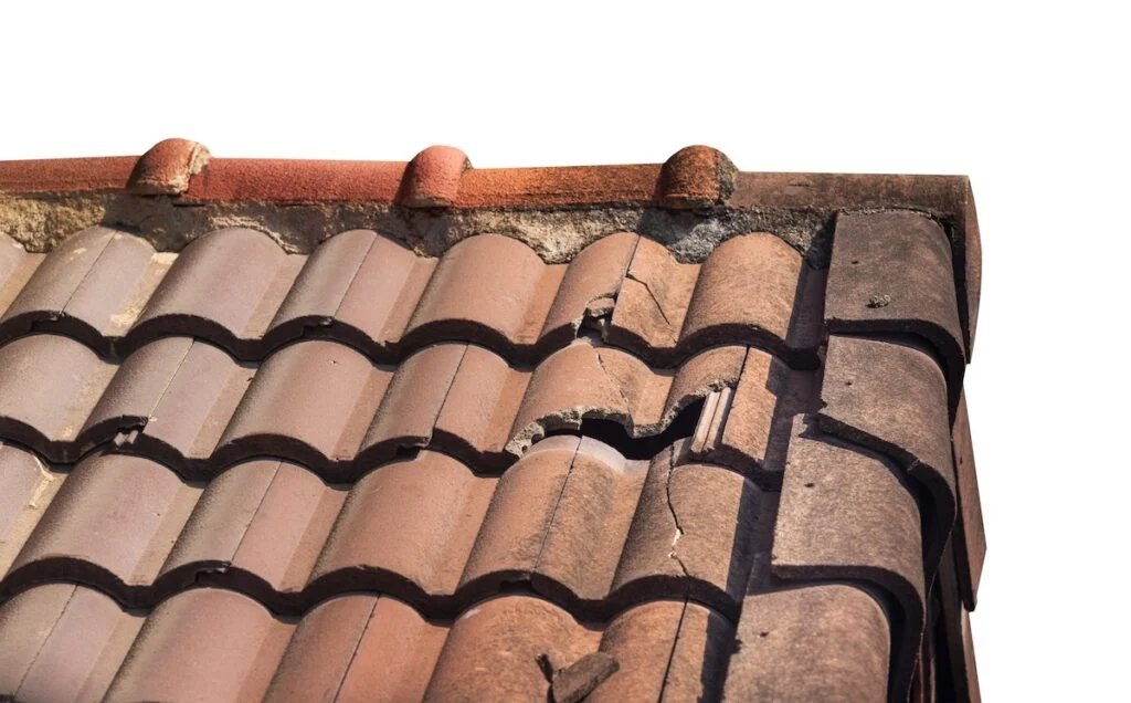 Cracked and broken roof tiles showing visible roof damage on a property in Milton Keynes.